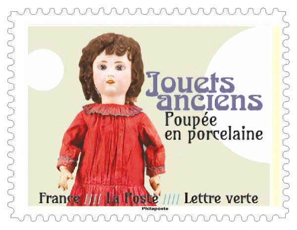 Timbre : JOUETS ANCIENS - Poupée en porcelaine